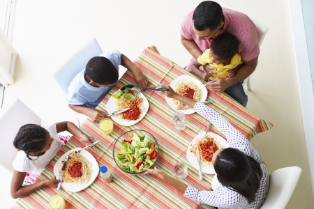 Overhead View Of Family Eating Meal Togetherの写真素材