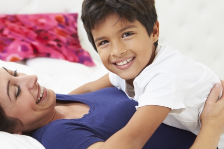 Mother And Son Lying In Bed Togetherの写真素材