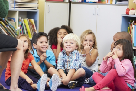 Group of Elementary Pupils In Classroom Touching Nosesの写真素材