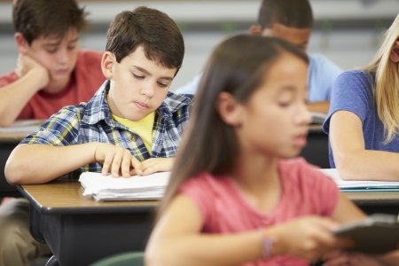 Pupils Studying At Desks In Classroomの写真素材