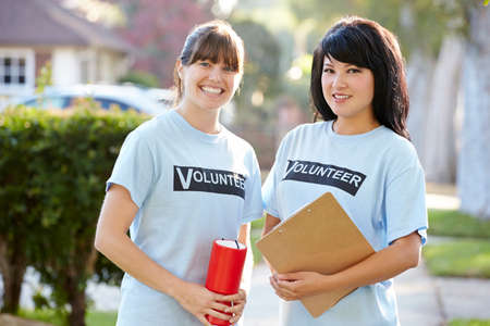 Portrait Of Two Female Charity Volunteers On Streetの写真素材