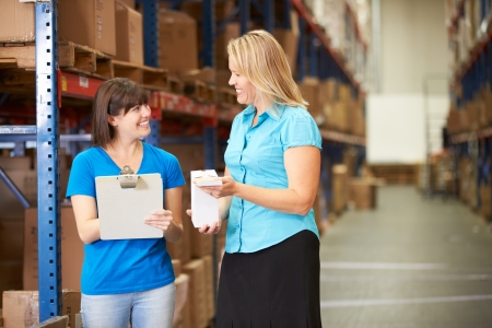 Businesswoman And Female Worker In Distribution Warehouseの写真素材