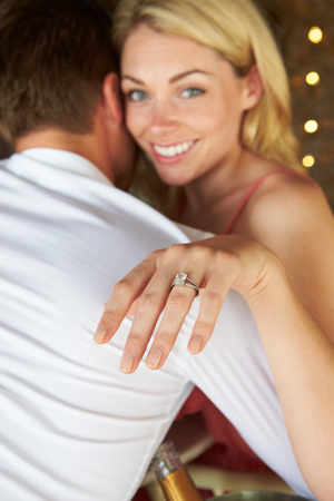 Man Proposing To Woman In Restaurantの写真素材