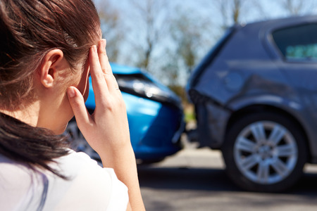 Stressed Driver Sitting At Roadside After Traffic Accidentの写真素材