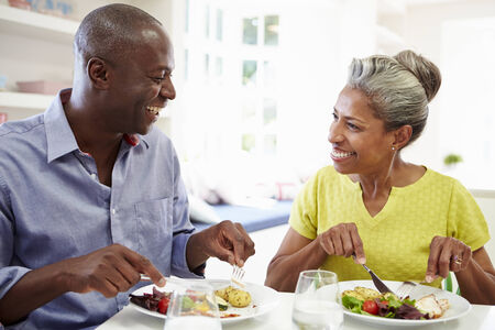 Mature African American Couple Eating Meal At Homeの写真素材