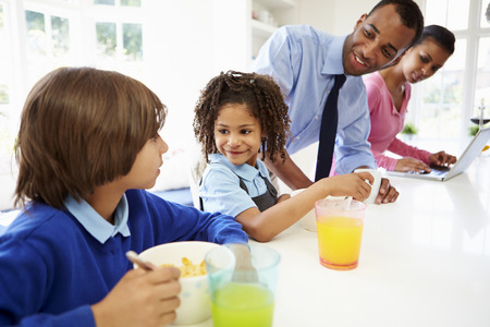 Family Having Breakfast In Kitchen Before School And Workの写真素材