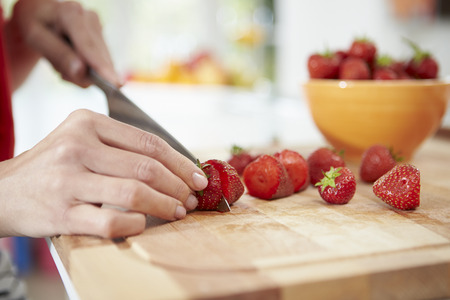 Close Up Of Woman Preparing Fruit Saladの写真素材