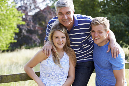 Father With Teenage Children Walking In Countrysideの写真素材