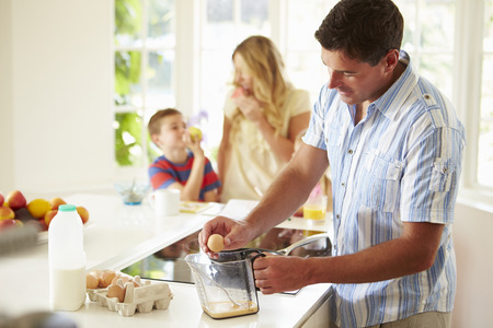 Father Preparing Family Breakfast In Kitchenの写真素材