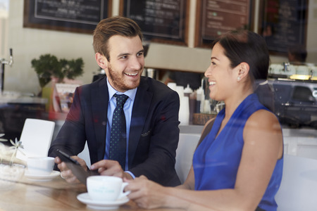 Businessman And Businesswoman Meeting In Coffee Shopの写真素材