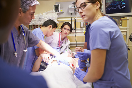 Medical Team Working On Patient In Emergency Roomの写真素材