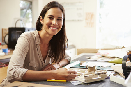 Female Architect Making Model In Office