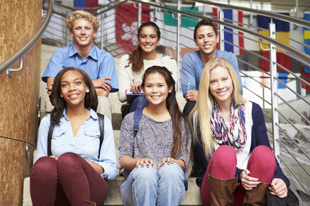 Portrait Of High School Students Sitting Outside Buildingの写真素材