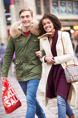 Young Couple Shopping Outdoors Togetherの写真素材