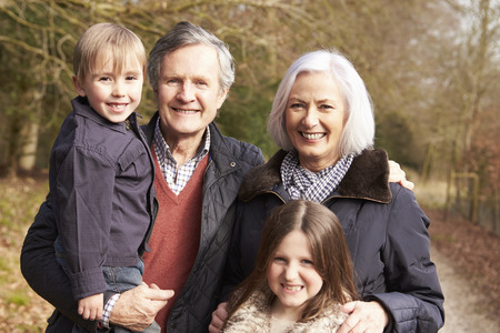 Grandparents With Grandchildren On Walk In Countrysideの写真素材