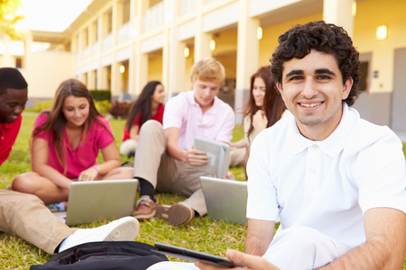 High School Students Studying Outdoors On Campusの写真素材