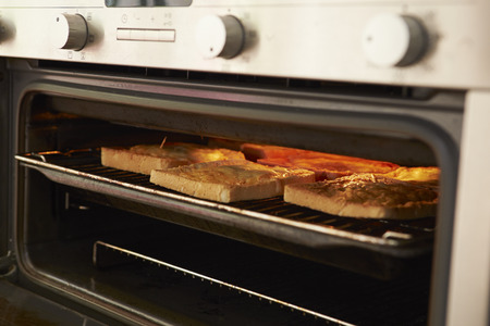 Cheese On Toast Being Grilled In Ovenの写真素材