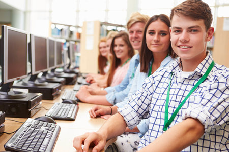 Group Of Students Working At Computers In Library