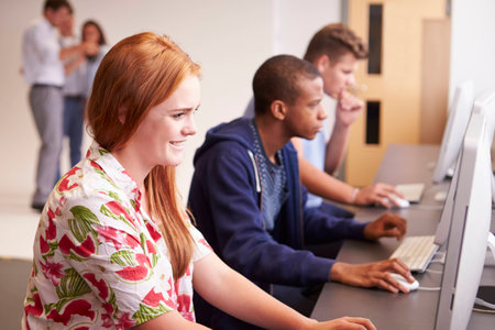 College Students Using Computers On Media Studies Course