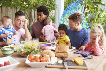 Depressed Father With Baby Talking To Friends