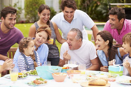 Multi Generation Family Celebrating Birthday In Garden