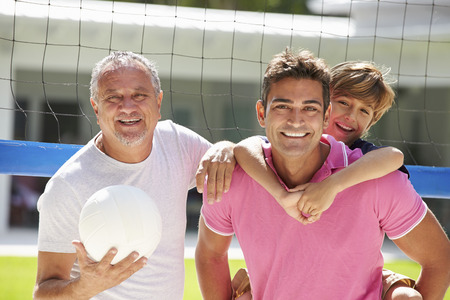 Male Multi Generation Family Playing Volleyball In Gardenの写真素材