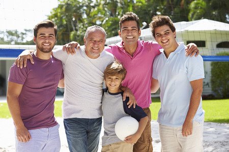 Male Multi Generation Family Playing Volleyball In Gardenの写真素材