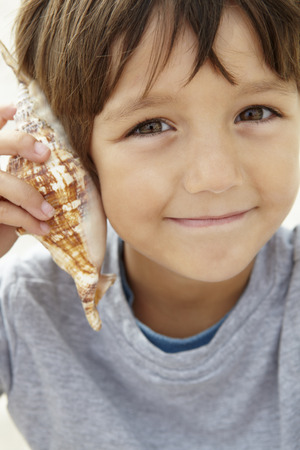 Young boy with seashellの写真素材
