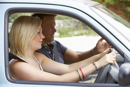 Teenage girl learning to driveの写真素材