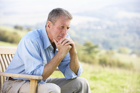 Senior man sitting outdoorsの写真素材
