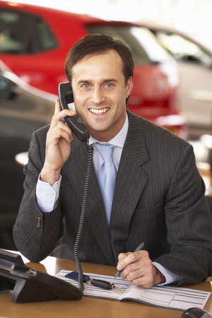 Man working in car showroomの写真素材
