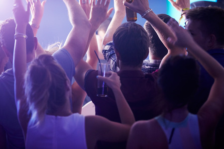 Rear View Of People Dancing In Nightclub