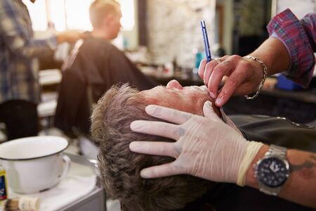 Barber Shaving Client With Cut Throat Razorの写真素材