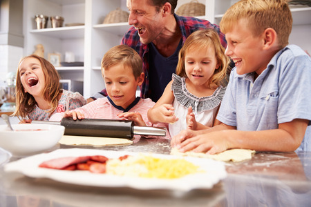 Father making pizza with his kidsの写真素材
