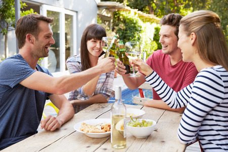 Group Of Friends Enjoying Outdoor Drinks In Gardenの写真素材