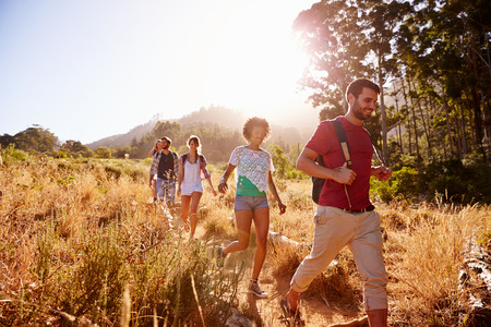Group Of Friends On Walk Through Countryside Togetherの写真素材