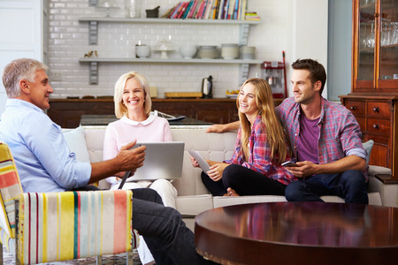 Parents With Adult Offspring Using Digital Devices At Home