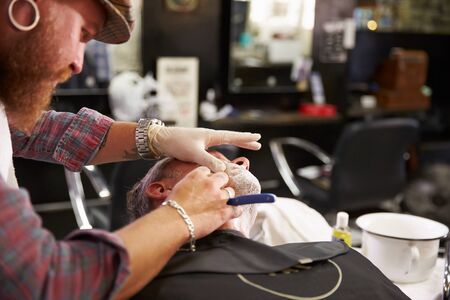 Barber Shaving Client With Cut Throat Razorの写真素材