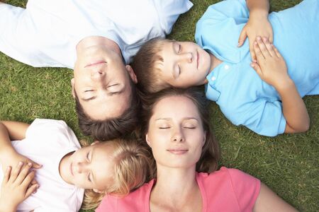 Overhead View Of Family Resting On Grassの写真素材