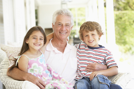 Grandfather With Grandchildren At Home
