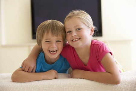 Children Watching Widescreen TV At Homeの写真素材