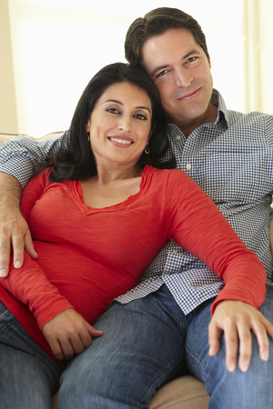 Hispanic Couple Relaxing At Homeの写真素材