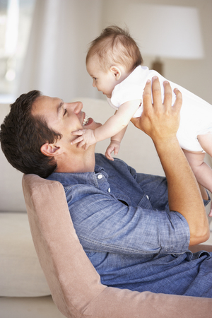 Young Father On Sofa At Homeの写真素材
