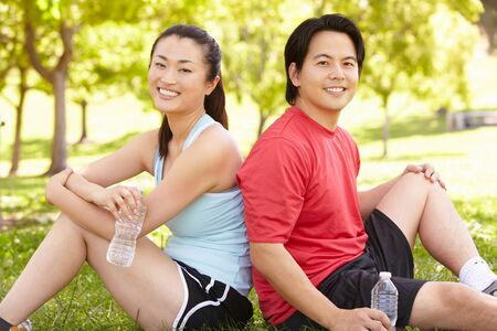 Asian couple resting after exerciseの写真素材