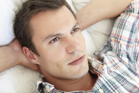 Young Man Relaxing On Bedの写真素材