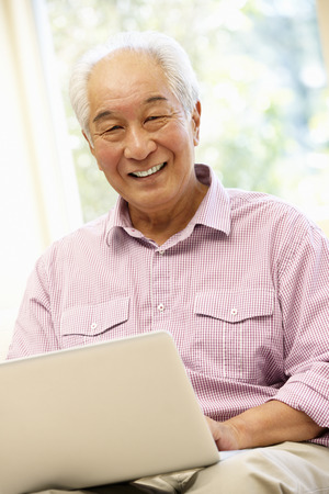 Senior Asian man using laptopの写真素材
