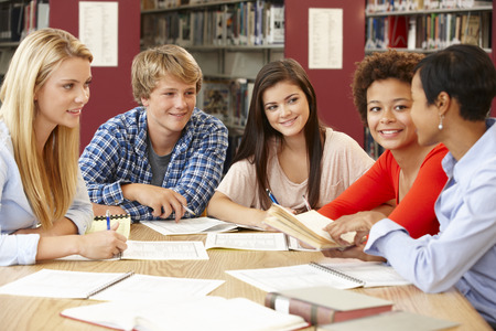 Group of students working together in libraryの写真素材