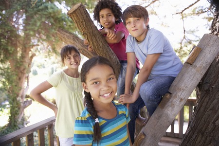 Group Of Children Hanging Out In Treehouse Togetherの写真素材