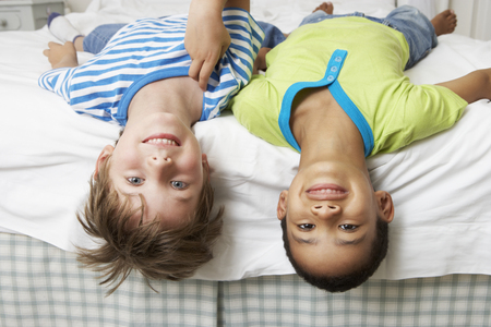 Two Boys Playing On Bed Togetherの写真素材