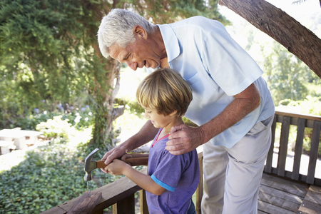 Grandfather And Grandson Building Tree House Togetherの写真素材